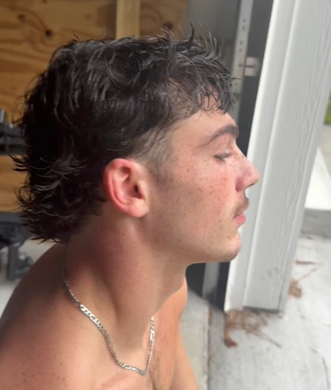 Modern dark mullet with tapered sides and natural texture