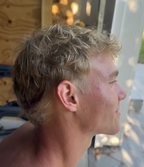 Soft blond texture above a clean low taper